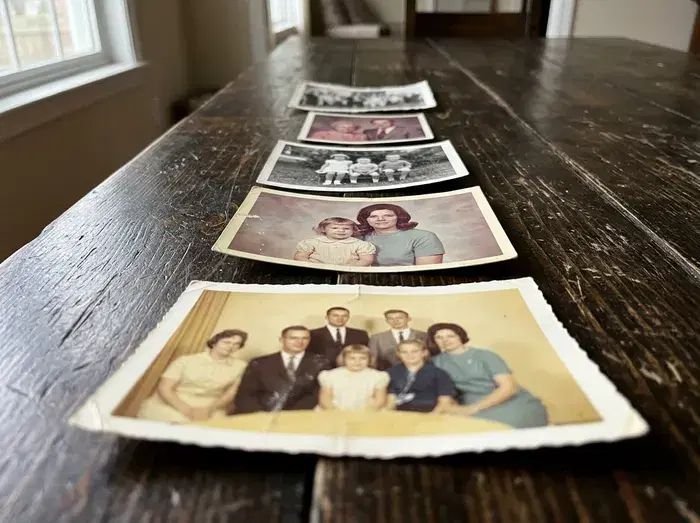 Prints on a table photographed from a low angle, so the far ones look small and slanted.